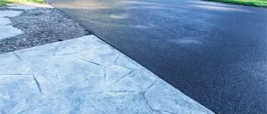 Fresh concrete driveway being paved and leveled